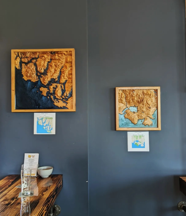 Two wooden maps hanging at a brewery